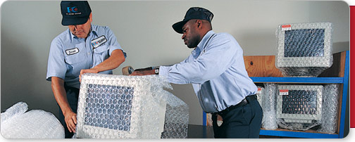 EDC employees packing computer monitors